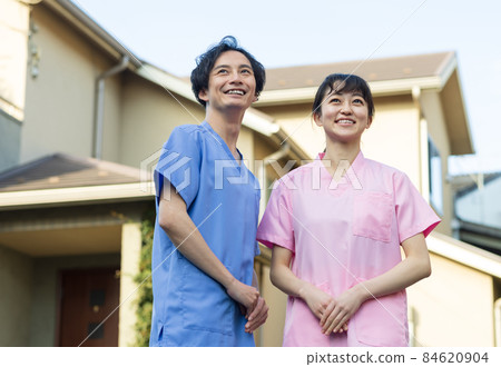Medical staff standing in a residential area Medical staff standing in a residential area 84620904