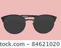 Sunglasses. Black sunglasses, close-up. Sun glasses. Old style sunglasses. Glasses with dark lenses. Vintage sun glasses on pale rossete color background. Close up of worn out sunglasses. Horizonatal 84621020