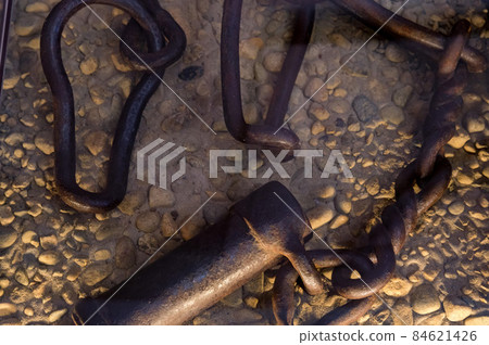 Ancient fetters or legcuffs on the ground close-up Ancient fetters or legcuffs on the ground close-up 84621426