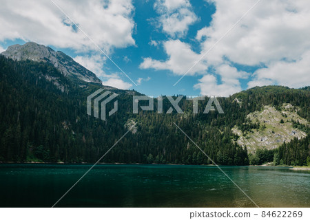 Mountain lake in Durmitor National Park, Montenegro. BEAUTIFUL VIEW OF THE MOUNTAIN LANDSCAPE WITH CLEAR WATER AND BRIGHT BLUE SKY Mountain lake in Durmitor National Park, Montenegro. BEAUTIFUL VIEW OF THE MOUNTAIN LANDSCAPE WITH CLEAR WATER AND BRIGHT BLUE SKY 84622269