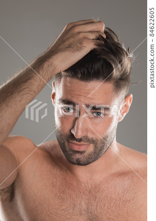 Handsome naked man touching his hair 84622605