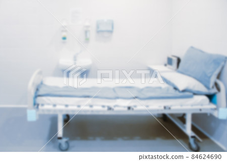 Blurred photo of the operating room in a hospital. Surgical equipment with operating table. Medical device for emergency patient in blue tone style. Blank Surgery Room. Clinic interior for background. 84624690