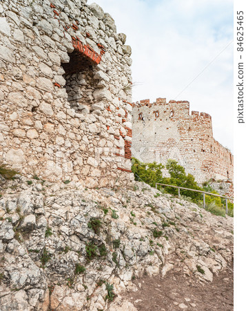 Climbing to a castle from the thirteenth century built from white limestone. 84625465