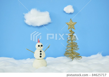 snowman near golden tree top star decoration in Christmas and new year festival with snow made by cotton diorama on sky background snowman near golden tree top star decoration in Christmas and new year festival with snow made by cotton diorama on sky background 84625717