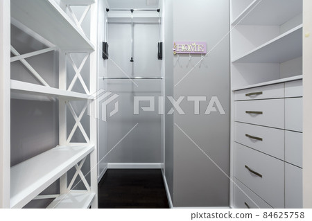 Emplty closet for storing of clothes in brdroom. Shelves and two level clothes rods are built in Emplty closet for storing of clothes in brdroom. Shelves and two level clothes rods are built in 84625758