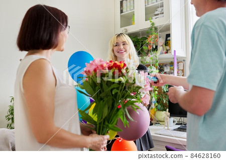 Parents congratulating teenage daughter with happy birthday Parents congratulating teenage daughter with happy birthday 84628160