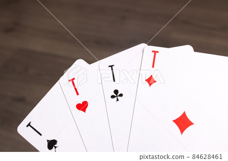 Four aces close up on wooden background Four aces close up on wooden background 84628461