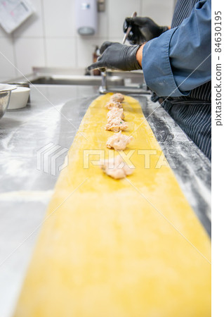 process of preparation of Italian pasta, handmade pasta, Italian gastronomy 84630195