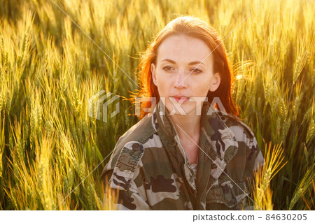 Portrait of a young happy girl sitting on gold Portrait of a young happy girl sitting on gold 84630205