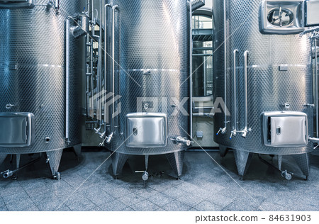 Modern stainless steel wine vats in winery. 84631903