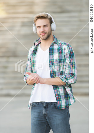 Modern man listening music wireless headphones, way to university concept Modern man listening music wireless headphones, way to university concept 84631910