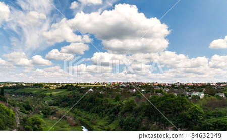 Canyon of the river and houses under cloudy sky in Kamenetz Podolsky 84632149