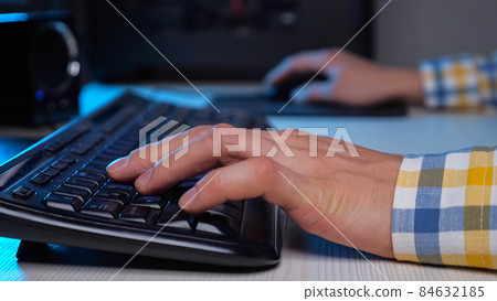 Gamer man hands play videogame with keyboard and mouse Gamer man hands play videogame with keyboard and mouse 84632185