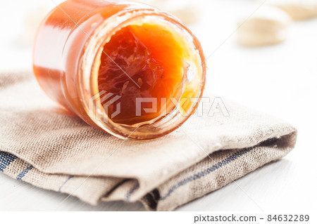 dense jam in jar spoon 84632289