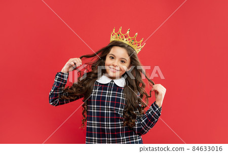smiling teen girl with curly hair wear crown on red background, winner 84633016