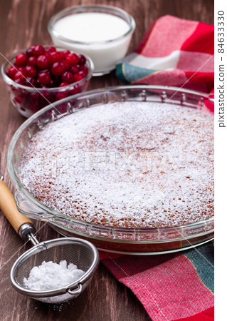 Swedish saffron Kladdkaka, pie with white chocolate, whipping cream and cranberry, vertical 84633330