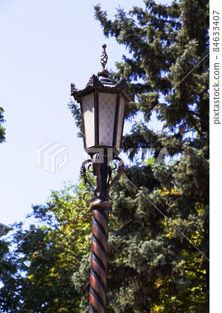 An old iron lantern. Garden electric lamp in the park An old iron lantern. Garden electric lamp in the park 84633407