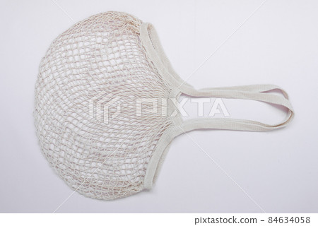 Mesh Shopping Bag. The concept of love and care for the environment. Sustainable shopping. Reuse. Shopping Mesh Shopping Bag. The concept of love and care for the environment. Sustainable shopping. Reuse. Shopping 84634058