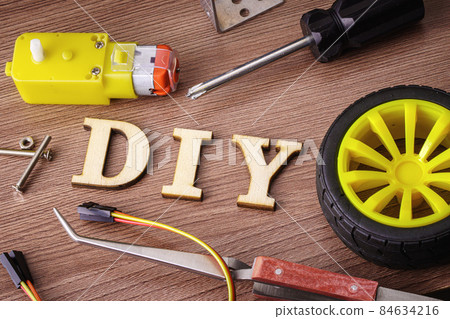DIY spelled in wooden letters on the table 84634216