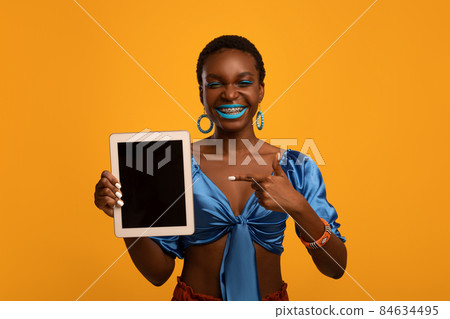 Stylish black lady showing digital tablet with empty screen 84634495