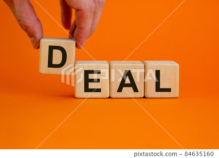 Fees symbol. Concept word 'fees' on cubes on a beautiful orange background. Male hand. Business and fees concept. Copy space. Fees symbol. Concept word 'fees' on cubes on a beautiful orange background. Male hand. Business and fees concept. Copy space. 84635160
