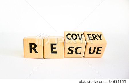 Recovery and rescue symbol. Turned cubes and changed the word 'recovery' to 'rescue'. Beautiful white background. Business and recovery - rescue concept. Copy space. Recovery and rescue symbol. Turned cubes and changed the word 'recovery' to 'rescue'. Beautiful white background. Business and recovery - rescue concept. Copy space. 84635165