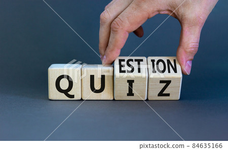 Quiz or question symbol. Businessman hand turns cubes and changes the word 'quiz' to 'question'. Beautiful grey background. Business quiz or question concept. Copy space. Quiz or question symbol. Businessman hand turns cubes and changes the word 'quiz' to 'question'. Beautiful grey background. Business quiz or question concept. Copy space. 84635166