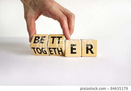 Better together symbol. Businessman turns cubes and changes the word together to better. Beautiful white table, white background, copy space. Business, motivational and better together concept. Better together symbol. Businessman turns cubes and changes the word together to better. Beautiful white table, white background, copy space. Business, motivational and better together concept. 84635179