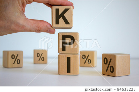 Male hand placing a cube with letter K on top of a other cubes. KPI word. Beautiful white background. Concept of successful business processes. 84635223