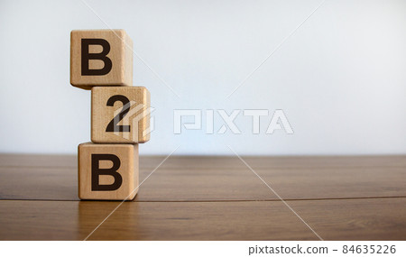 Concept word 'B2B' on cubes on a beautiful wooden table. White background. Business concept. Copy space. Concept word 'B2B' on cubes on a beautiful wooden table. White background. Business concept. Copy space. 84635226