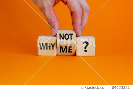 Why not me symbol. Businessman turns a cube and changes words why me to why not. Beautiful orange background. Business and why not me concept. Copy space. Why not me symbol. Businessman turns a cube and changes words why me to why not. Beautiful orange background. Business and why not me concept. Copy space. 84635231