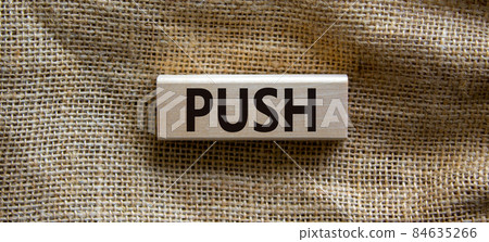 Wooden block form the word 'push' on beautiful canvas background. Business and push concept. Wooden block form the word 'push' on beautiful canvas background. Business and push concept. 84635266