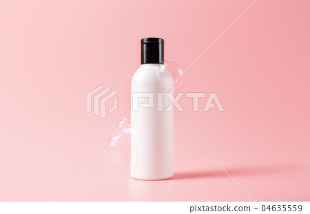 Shampoo bottle with soapy bubbles. Beauty skincare cosmetic packaging mockup Shampoo bottle with soapy bubbles. Beauty skincare cosmetic packaging mockup 84635559
