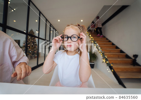Adorable little girl in glasess looking at the camera close-up 84635560