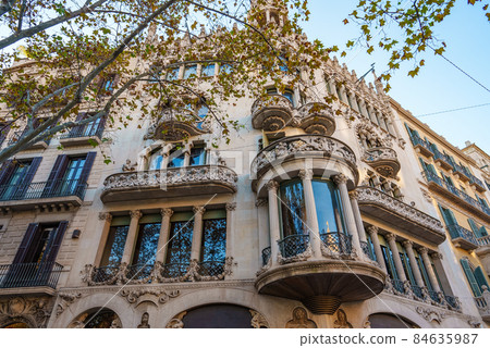 From below corner of old building with ornamental balconies located on sunny autumn day on street of Barcelona, Spain From below corner of old building with ornamental balconies located on sunny autumn day on street of Barcelona, Spain 84635987