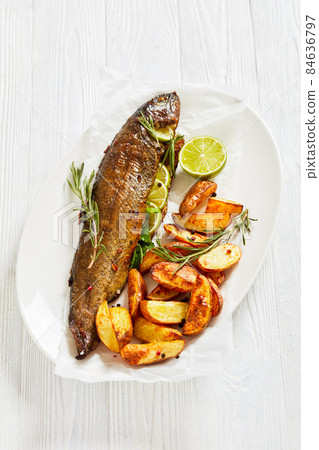baked trout fish with roast potatoes, top view 84636797