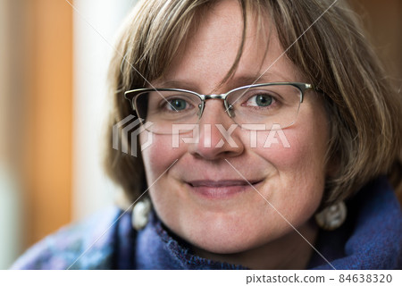 Indoor head shot portrait of a white htirty year old woman Indoor head shot portrait of a white htirty year old woman 84638320