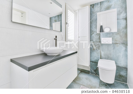 Stylish bathroom with large marble tiles on the walls and floor 84638518