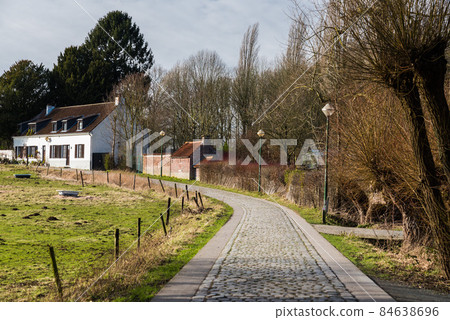 Country house at the end of a paved road, scenic nature scene at the Brussels countryside 84638696