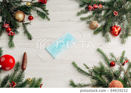 Christmas Composition with Mask on a White Wooden Table with Copy Space 84639232