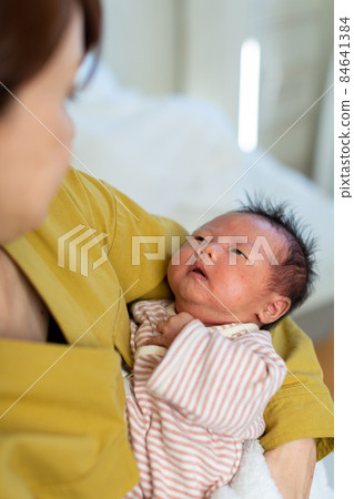 Breastfeeding mom and 1 month old baby 84641384