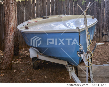 sailing dinghy on a trailer in backyard 84641643