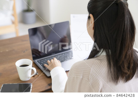 A woman touching a personal computer A woman touching a personal computer 84642428