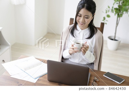 A woman touching a personal computer A woman touching a personal computer 84642430