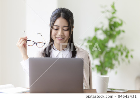A woman touching a personal computer A woman touching a personal computer 84642431