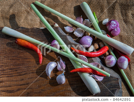 Herbs and ingredient mixed (Lemon Grass, Shallot, Garlic, Chili) on wooden chopping board. 84642891