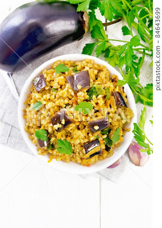 Bulgur with eggplant in bowl on light board top 84643699