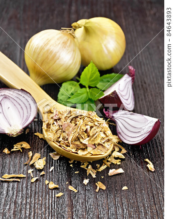 Onion flakes in spoon on table Onion flakes in spoon on table 84643893