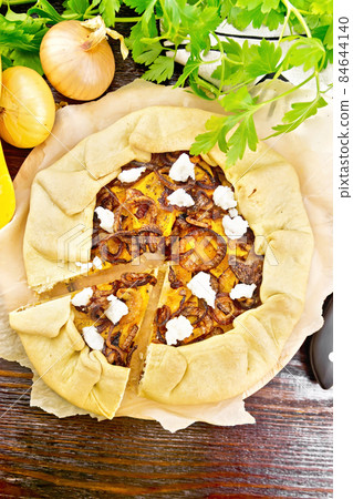 Pie with pumpkin and onions on board top 84644140