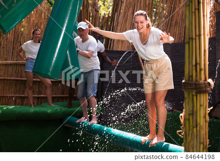 Friends are looking for adventure in an amusement park 84644198